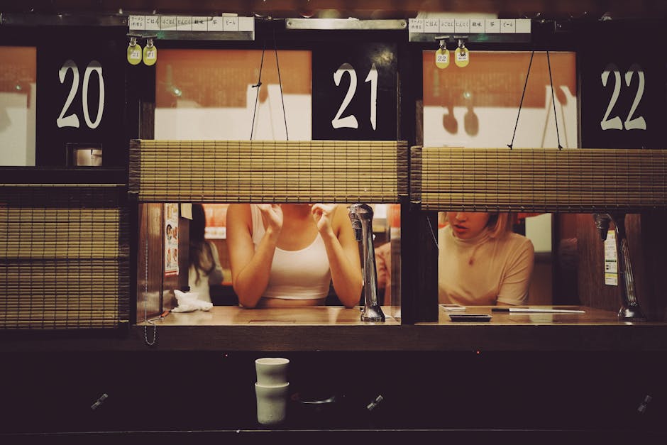 Intimate dining experience at a ramen restaurant in Shibuya, Tokyo with individual booths.