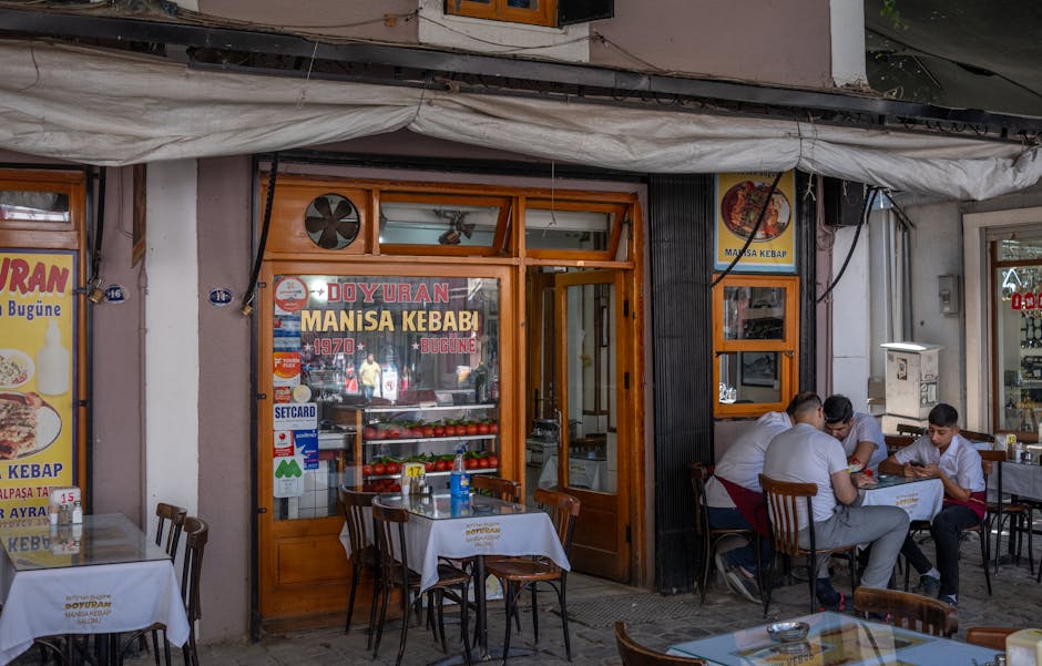 People enjoying outdoor dining at Doyuran Manisa Kebab in vibrant İzmir city street.